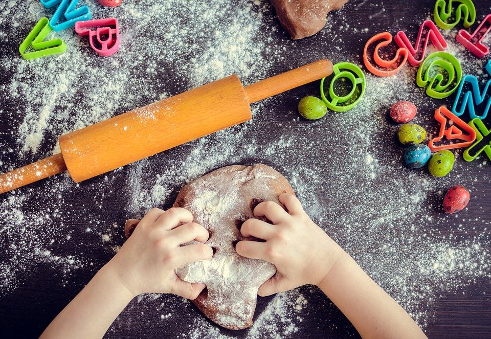 young girl's hands kneading dough