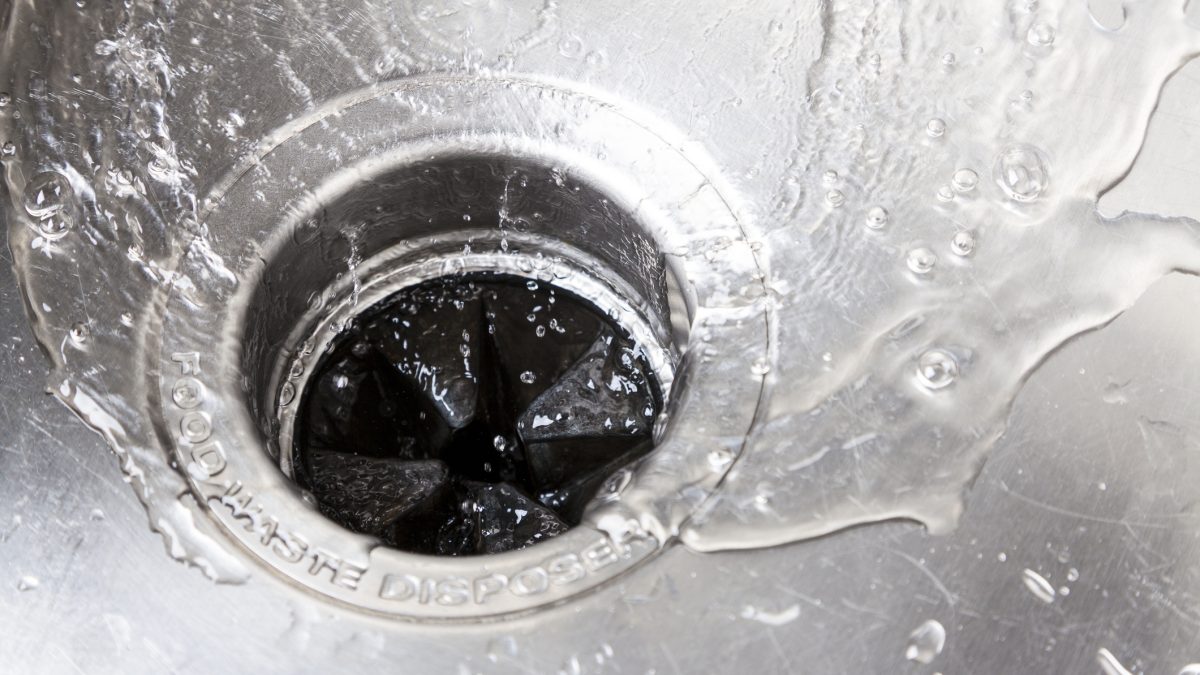 Stainless steal kitchen sink draining water